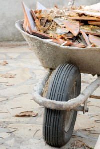 old used wheelbarrow details with construction waste, broken tiles pieces