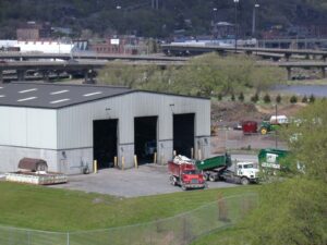 aerial image of transfer station with garbage trucks backing in to unload.